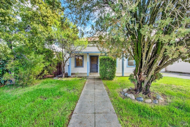 obstructed view of property featuring covered porch and a front yard