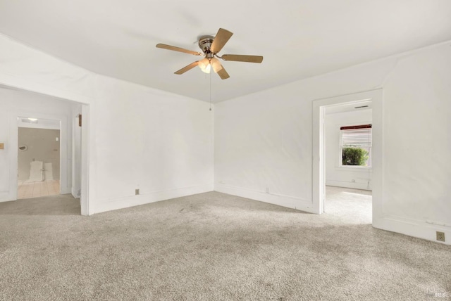 empty room featuring carpet flooring and a ceiling fan