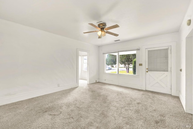 empty room featuring carpet flooring and a ceiling fan