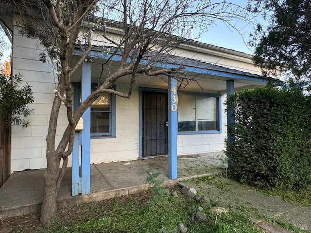 doorway to property featuring concrete block siding