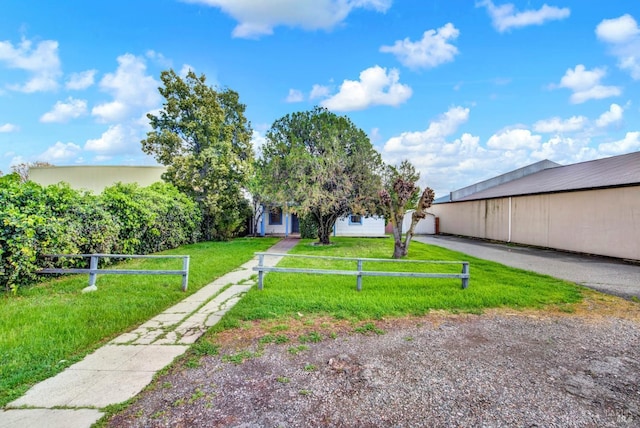 view of yard with an outbuilding, fence, and an outdoor structure