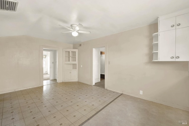 spare room with a ceiling fan, visible vents, light floors, and baseboards