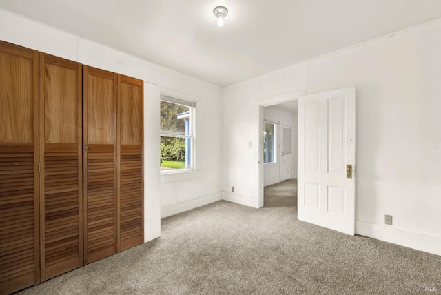 unfurnished bedroom featuring a closet and carpet