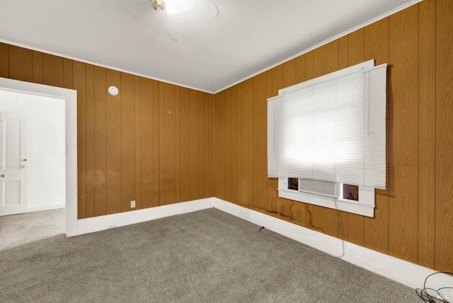 empty room with wooden walls, cooling unit, carpet, and ornamental molding