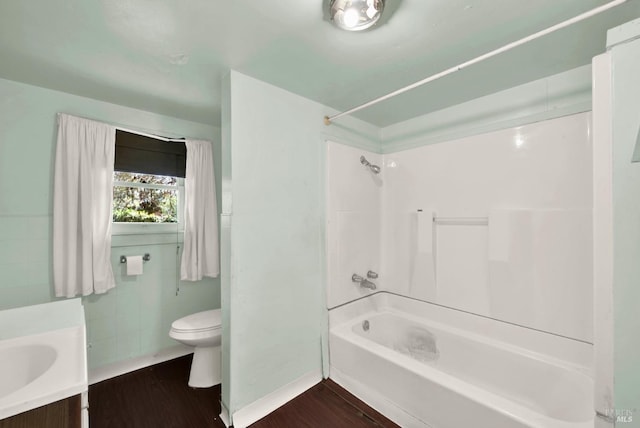 full bathroom with vanity, toilet, wood finished floors, and shower / bathtub combination