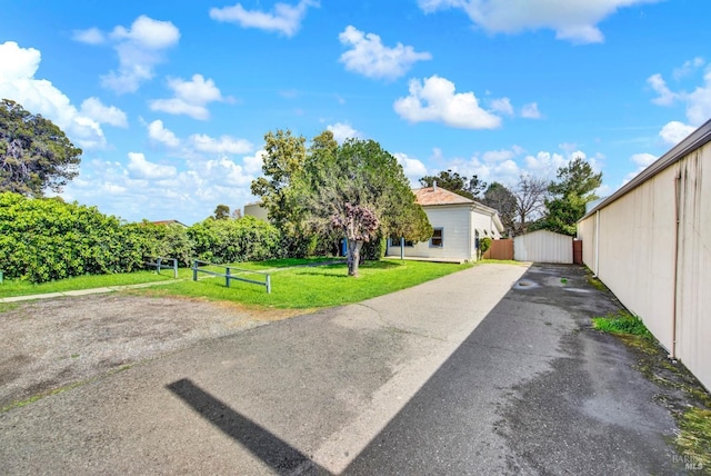 view of home's exterior featuring a lawn and fence