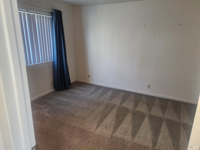 empty room with carpet flooring and baseboards