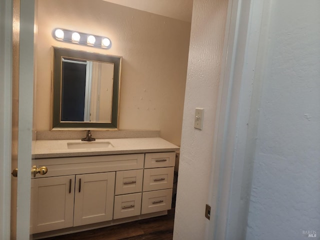 bathroom with vanity and wood finished floors