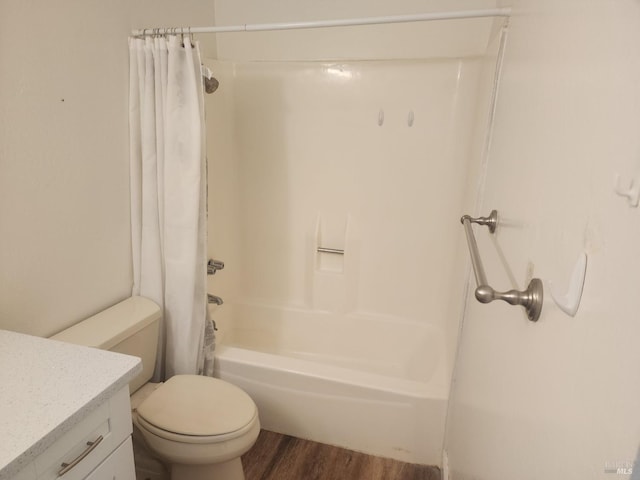 full bathroom featuring toilet, vanity, shower / tub combo, and wood finished floors