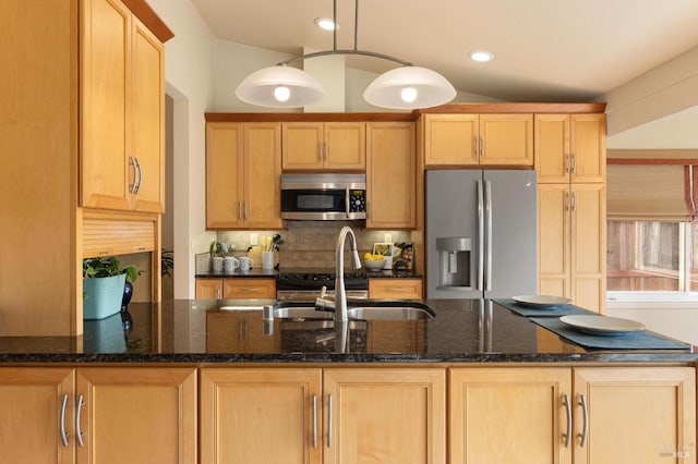 kitchen featuring recessed lighting, stainless steel appliances, dark stone countertops, backsplash, and a sink