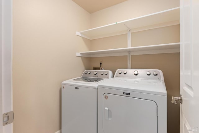 laundry area with independent washer and dryer, baseboards, and laundry area