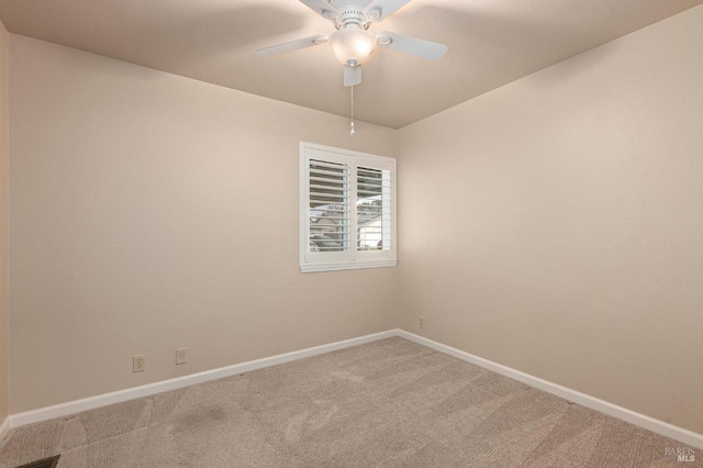 empty room featuring carpet flooring, baseboards, and ceiling fan