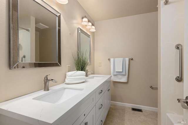 full bathroom featuring double vanity, visible vents, baseboards, and a sink