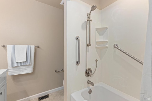 bathroom with baseboards, bathing tub / shower combination, visible vents, and vanity