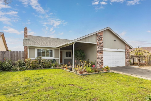 view of front of house with an attached garage, fence, and a front yard