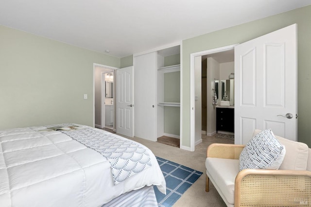 bedroom with carpet flooring, connected bathroom, and a closet