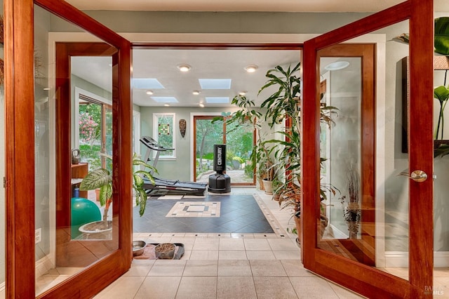 tiled entryway featuring a skylight