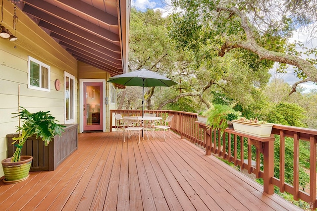 wooden terrace featuring outdoor dining area