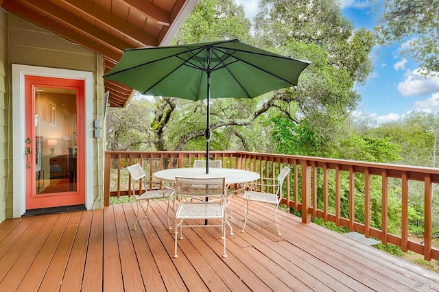 wooden terrace featuring outdoor dining space