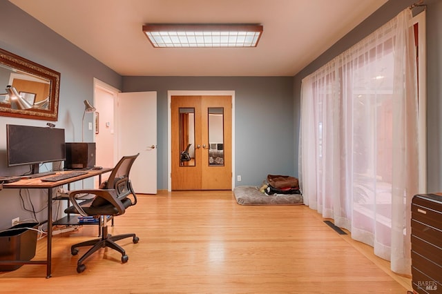 home office featuring visible vents and light wood-style floors