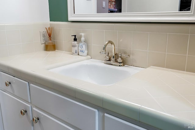 bathroom featuring backsplash and a sink