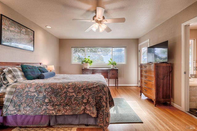 bedroom with ceiling fan, a textured ceiling, baseboards, and wood finished floors