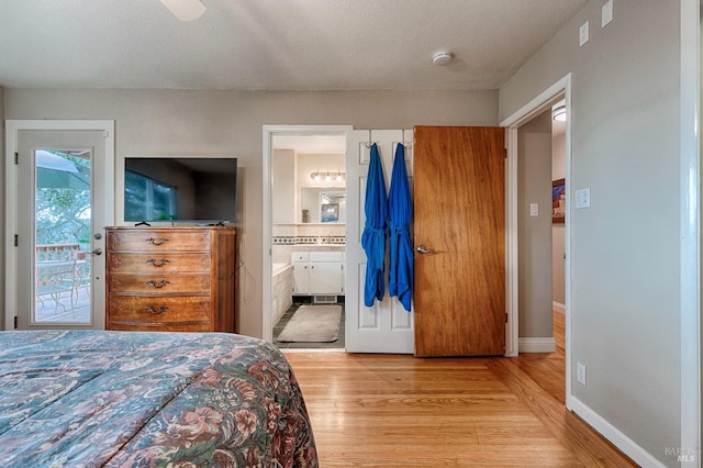 bedroom with access to outside, ensuite bathroom, baseboards, and light wood finished floors