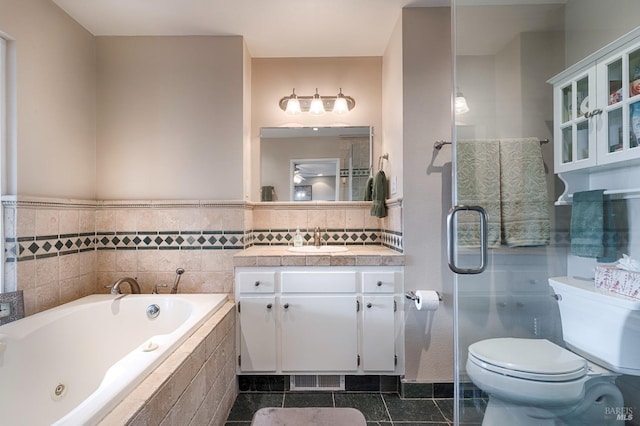 full bath with a shower with shower door, toilet, a jetted tub, tile patterned flooring, and vanity