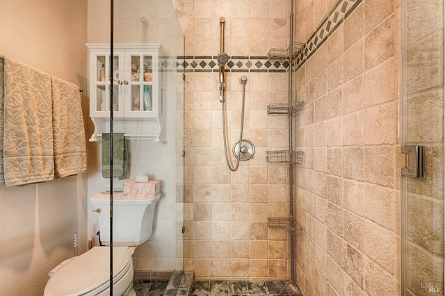 bathroom featuring toilet and tiled shower