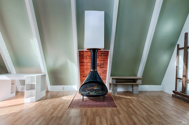 details with a wood stove and wood finished floors