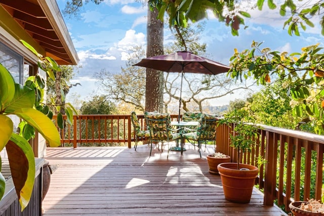 wooden terrace with outdoor dining area