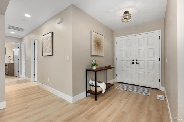 entryway featuring recessed lighting, baseboards, visible vents, and light wood finished floors