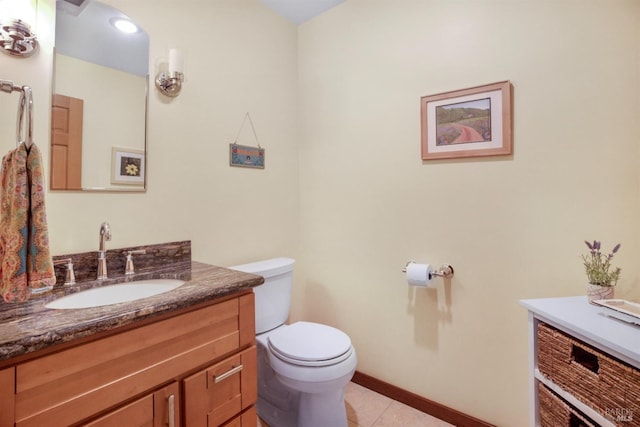 half bath with tile patterned floors, baseboards, toilet, and vanity