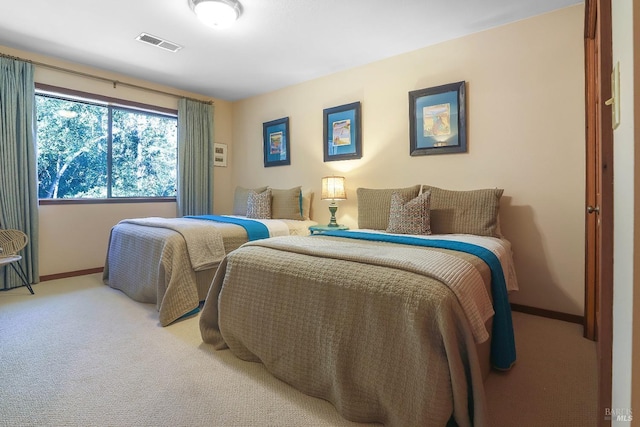 bedroom with visible vents, light colored carpet, and baseboards