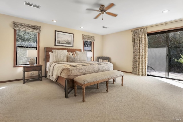 bedroom with access to outside, light colored carpet, and visible vents