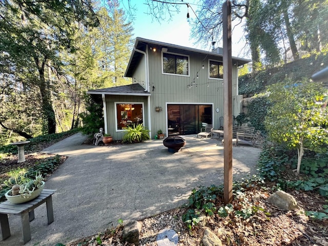 back of house featuring a fire pit and a patio