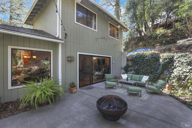 exterior space with an outdoor living space with a fire pit