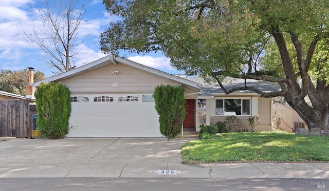 single story home featuring a front yard, concrete driveway, a garage, and fence