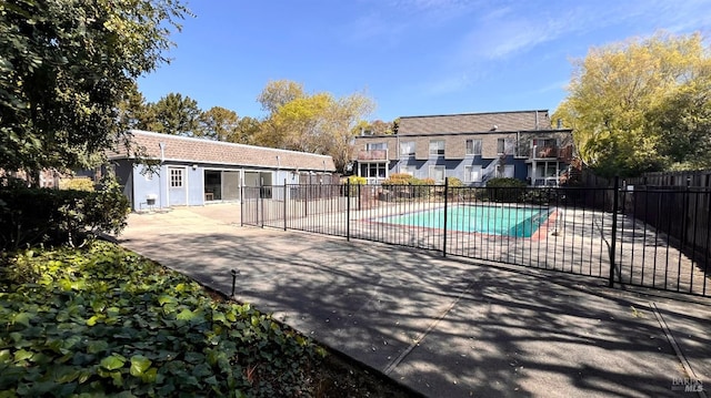 view of swimming pool with a fenced in pool, a patio, and fence