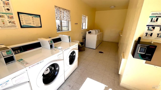 community laundry room with separate washer and dryer