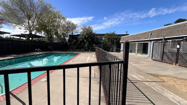 view of swimming pool with a fenced in pool, a patio area, and fence