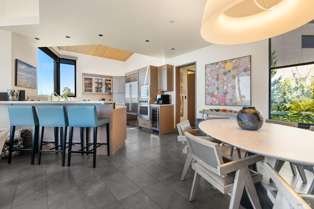 interior space with plenty of natural light, beverage cooler, and dark tile patterned flooring