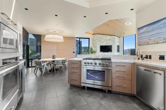 kitchen with dark tile patterned flooring, modern cabinets, stainless steel appliances, and backsplash