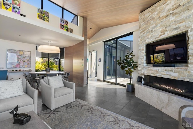 tiled living room with high vaulted ceiling, wooden ceiling, and a stone fireplace