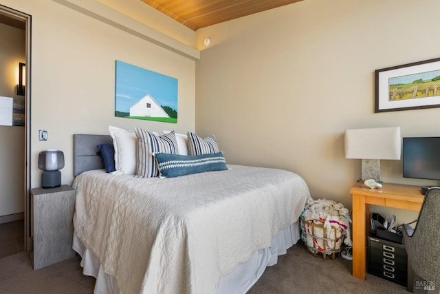 bedroom with wooden ceiling and carpet