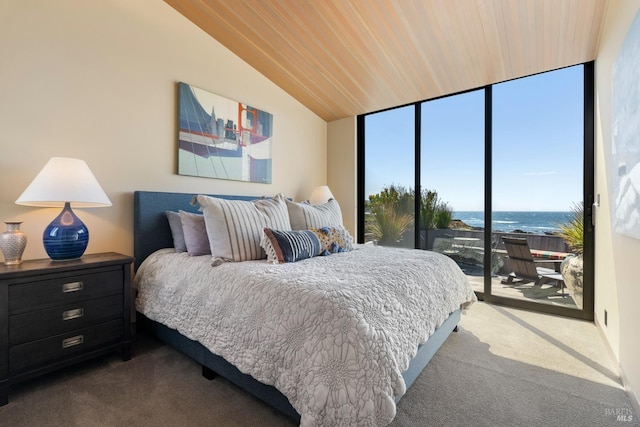 carpeted bedroom featuring access to exterior, floor to ceiling windows, a water view, and vaulted ceiling