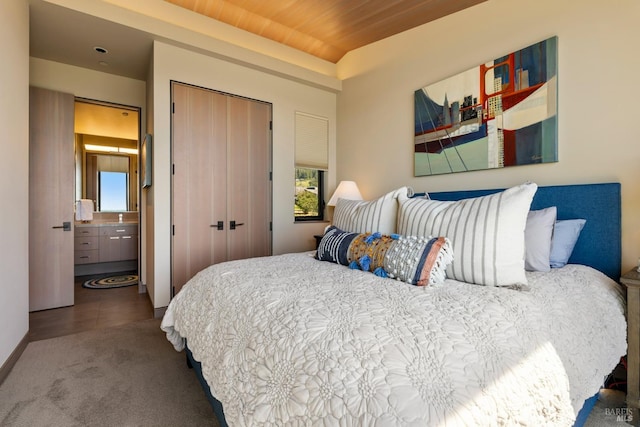carpeted bedroom featuring a closet and wooden ceiling