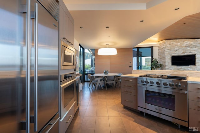 kitchen with light countertops, built in appliances, modern cabinets, gray cabinetry, and tile patterned flooring