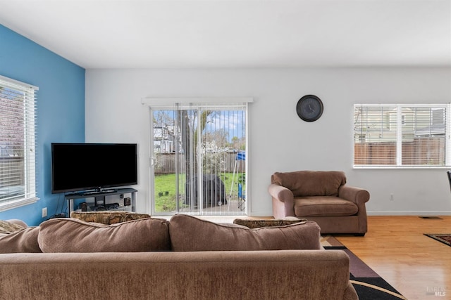 living room featuring wood finished floors and baseboards