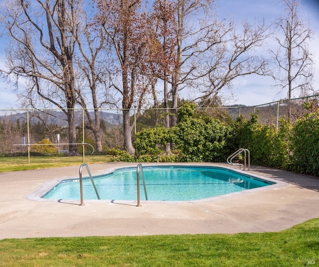 view of pool with a patio area, fence, and a fenced in pool